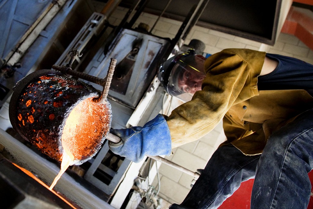 Sculptor Frank Sheriff at the University of Hawaii foundry, poring bronze into one of his molds
